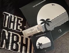 various records are laying on the floor next to each other, including one with an image of a palm tree