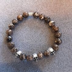 "Handmade with 8mm natural Turritella agate and sterling silver skulls on quality stretch cord. Great for everyday wear. Natural Turritella agate beads and sterling silver skulls were used in this bracelet. Any toggles, clasps, or othersilver beads are sterling silver. Bracelet length information: Stretchy bracelets will fit 7-7.5\"inch wrists. PLEASE REACH OUT WITH QUESTIONS OR FOR CUSTOM ORDERS. THANKS FOR VISITING MY SHOP AND PLEASE CHECK OUT THE OTHER AVAILABLE ITEMS" Turritella Agate, Stretchy Bracelets, Agate Beads, Sterling Silver Bracelet, Custom Orders, Silver Bracelet, Agate, Jewelry Bracelets, Everyday Wear