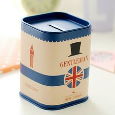 a candle that is sitting on a table next to a pen and pencil box with the name gentleman written on it