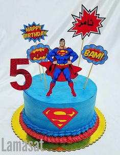 a superman birthday cake with the number five on it