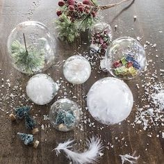 snow globes and feathers on a wooden table