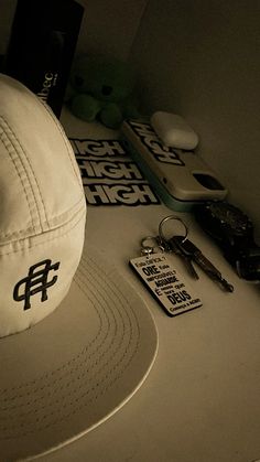 a hat, keys and other items are sitting on a table