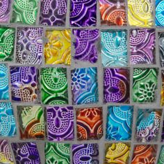 colorful glass tiles with different designs on them