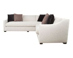 a white couch with pillows on it and a black pillow sitting next to the couch