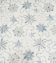 a white and blue floral print fabric with silver sequins on the bottom half