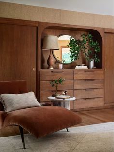 a living room scene with focus on the chaise lounge chair and wooden cabinetry