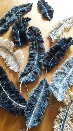 several pieces of blue and white feathers on a table