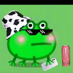 a green frog with a black and white hat next to a can of soda