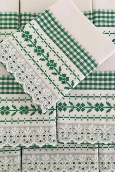 the green and white table cloths are on top of each other in different patterns