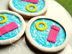 three decorated cookies sitting on top of each other in front of an instagramr