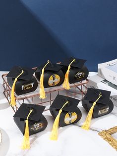 graduation caps and tassels are sitting on a table next to other items in a basket