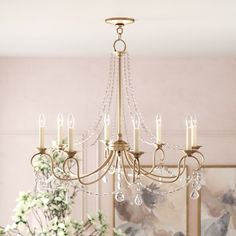 a chandelier hanging from the ceiling in a dining room