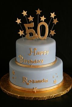 a blue and gold 50th birthday cake with stars