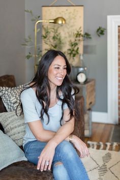 a woman sitting on top of a couch in a living room