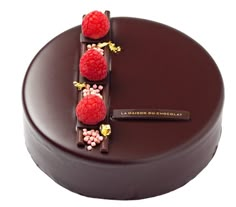 a chocolate cake with raspberries on top