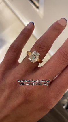 a woman's hand with a ring on it and the words wedding band rings with your selfie ring