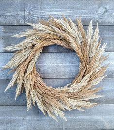 a dried wreath on a wooden wall