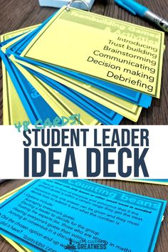 a pile of blue and yellow business cards with the words student leader idea deck on them