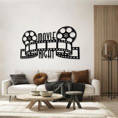 a living room filled with furniture and a wall mounted movie reel