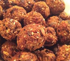 a white bowl filled with granola balls on top of a table