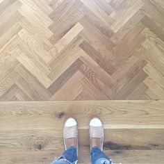 a person standing on top of a wooden floor