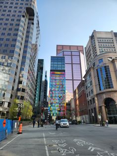 the city street is lined with tall buildings