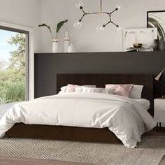 a bedroom with black walls and white bedding