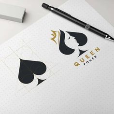 an open notebook with the queen logo on it next to a pen and paper pad