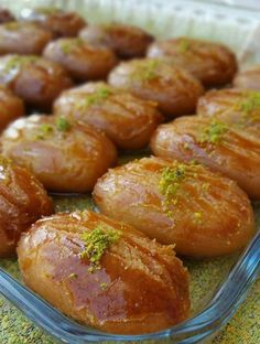 there are many small pastries in the glass dish