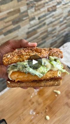 a person is holding up a sandwich with avocado on it and toasted bread