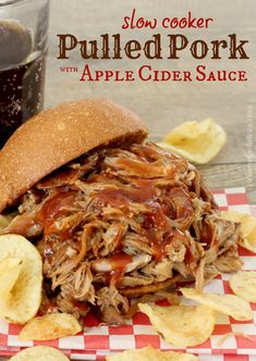 slow cooker pulled pork with apple cider sauce on a plate next to chips