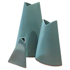 two blue vases sitting next to each other