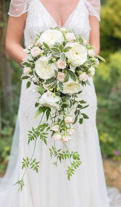 a bride holding a bouquet of flowers on her wedding day in the uk, with text overlay