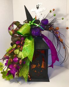 a purple and green halloween decoration on top of a lantern