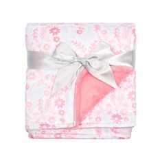 a pink and white blanket with a bow on the front, sitting in front of a white background