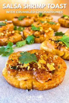 salsa shrimp toast with crumbled chicharros on a sheet of parchment paper