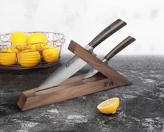 a knife holder with knives and lemons in the background