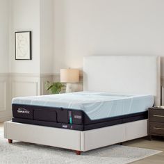 an image of a mattress that is in the middle of a room with a white headboard