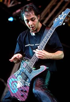 a man playing an electric guitar on stage