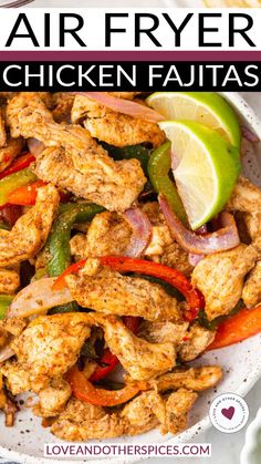 chicken fajitas with peppers, onions and limes in a white bowl on a table