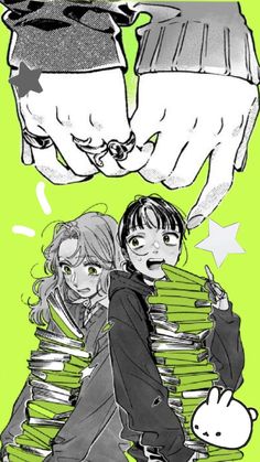 two people are holding stacks of books and one is pointing at the other person's hand