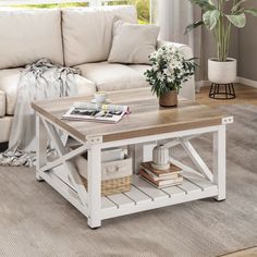 a living room with a white couch and coffee table