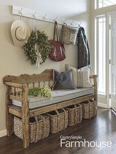 a wooden bench sitting in front of a window next to a wall mounted coat rack