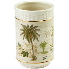 a white vase with a palm tree painted on the side and gold trimmings