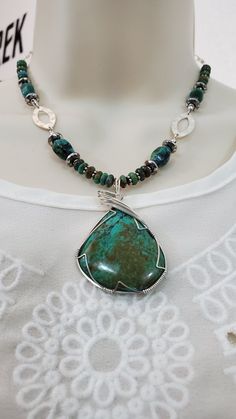 This Turquoise necklace features a beautiful natural Arizona Kingman turquoise stone wire-wrapped pendant. I cut & shaped this pendant stone from natural virgin rock and polished it to a high luster 50,000th diamond polish finish.  I then wire-wrapped the pendant stone using 6 bands of 24 gauge sterling silver wire, finishing of the wrap with my signature "sweep top bail design". This stone has a deep shine with a beautiful mixture of blue-greens color shades and a brown matrix. The turquoise pendant stone, wire-wrapped, measures about 2.15 inches long (5.30 centimeters) by 1.45 inches wide (3.60 centimeters).  The Turquoise pendant is the central focus piece of this turquoise necklace.  The necklace is comprised of various sized natural turquoise 6mm roundels & 11mm oval stones along with Turquoise Pendant Necklace, Sacred Stones, Deep Meditation, Turquoise Crystal, Third Eye Chakra, Kingman Turquoise, Turquoise Pendant, Wrapped Pendant, Natural Turquoise