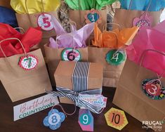 there are many bags with numbers on them and tags attached to the handles that say happy birthday