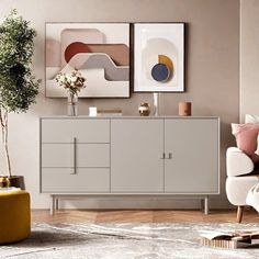 a living room scene with focus on the sideboard and artwork hanging over the couch