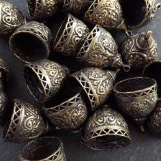 several metal bells sitting on top of a table