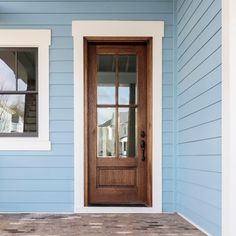 a blue house with a wooden door and window