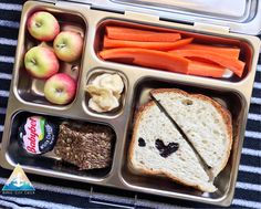 an open lunch box filled with fruit and vegetables